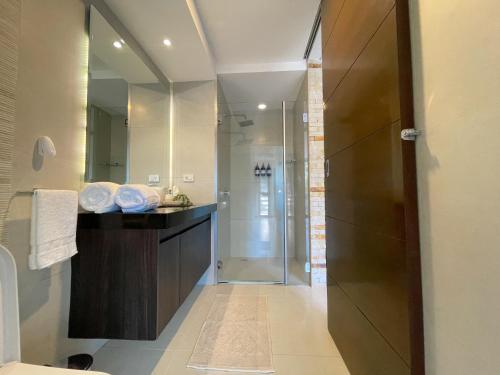 a bathroom with a shower and a sink and a mirror at Luxurious stay at modern apartment (Equipetrol) in Santa Cruz de la Sierra