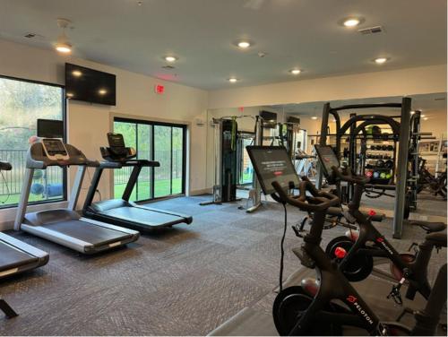 a gym with several treadmills and exercise bikes at Modern Austin 2BR 2B Apt with Pool Parking & WIFI in Austin