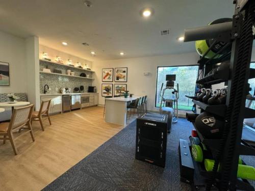 a room with a gym with a table and chairs at Modern Austin 2BR 2B Apt with Pool Parking & WIFI in Austin