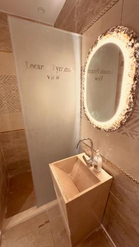 a bathroom with a sink and a mirror at Locanda pyramids view in Cairo