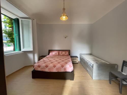 a bedroom with a bed and a bench in it at Casa al mare in Savona