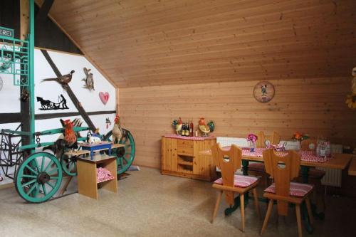 a room with a wooden cabin with a table and chairs at Ferienscheune Sächsische Schweiz in Lichtenhain