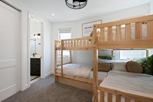 a bedroom with two bunk beds and a hallway at Desert Dream at Desert Color (by Ember Stays) in St. George