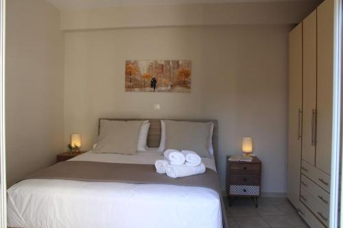 a bedroom with a bed with two towels on it at Apartment Lucia in Argostoli