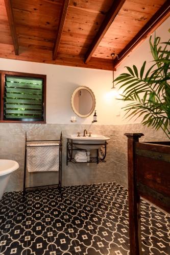 a bathroom with a sink and a mirror at Blue Fattoria Luxury Farm Accomodation in Fernside