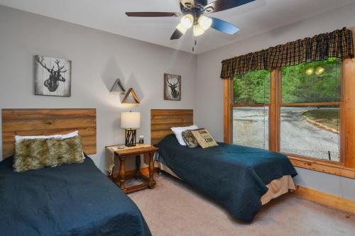 a bedroom with two beds and a window at Large Cabin to Enjoy in Coosawattee River Resort in Ellijay
