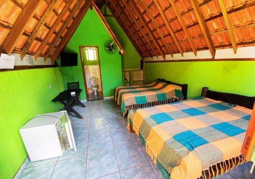 En eller flere senger på et rom på Pousada Rural Vargem do Cedro