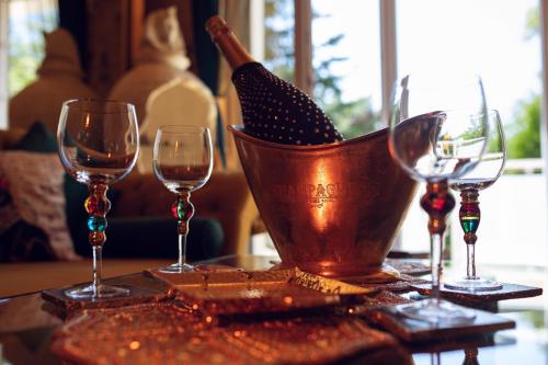 a group of wine glasses and a bucket on a table at Princess Palace in Gdańsk