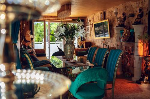 a room with a table and chairs and a vase with flowers at Princess Palace in Gdańsk