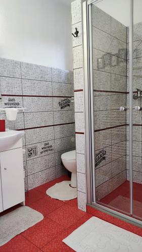 a bathroom with a toilet and a glass shower at Privat Voyage with Pool in Liptovský Mikuláš
