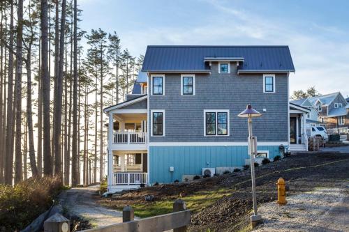 a house on top of a hill with trees at A Wave from It All by Seabrook Hospitality in Pacific Beach