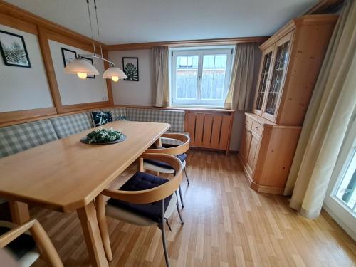 a dining room with a wooden table and chairs at ZADRA Home in Dornbirn