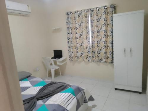 ein Schlafzimmer mit Bett, Schreibtisch und Fenster in der Unterkunft Ap 02-A 50 Metros da Praia Flats Mobiliados para 4 Pessoas in Paulista