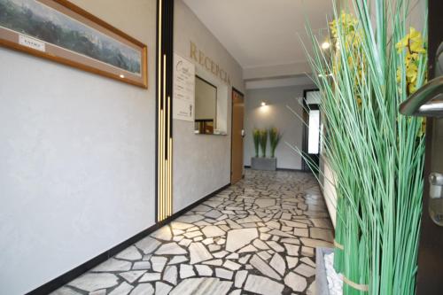 a hallway with a stone floor and plants at Motel Na Zbójeckiej in Skawa