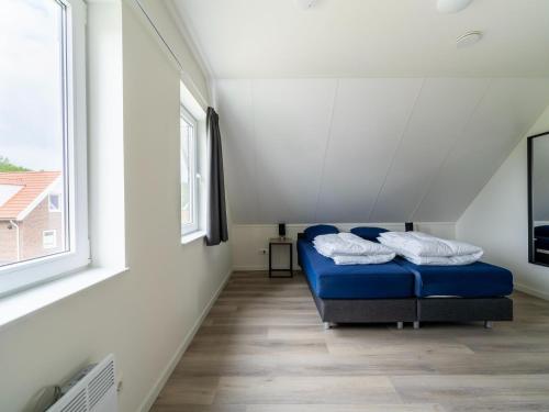 a bedroom with a bed in a room with a window at Holiday Home in South Holland by Stompaarde Plas in Simonshaven