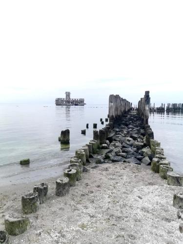 an old pier stretches out into the water at Apartament z widokiem na Morze przy Plaży Babie Doły Gdynia in Gdynia