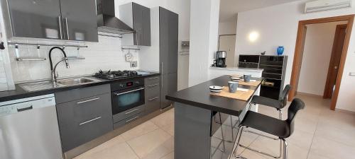 a kitchen with a sink and a counter top at Appartamento con posteggio privato in Portovenere