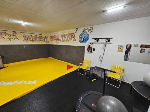 a room with a gym with a yellow trampoline at Miuti Residence in Triberg