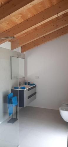 a bathroom with a sink and a blue chair at Loreto in Marone