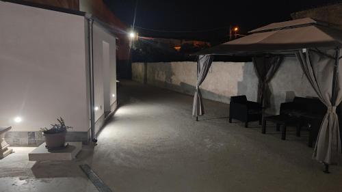 a patio with a tent and a table and chairs at Sicilia bedda in Custonaci