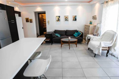 a living room with a couch and a table at Central cozy apt in quiet area in Engomi in Nicosia