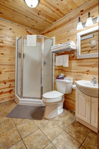 a bathroom with a shower and a toilet and a sink at Rock Crest Lodge & Cabins in Custer