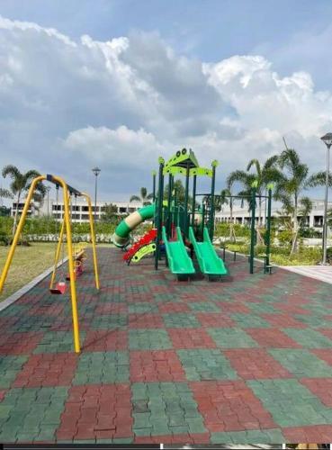 a playground with a slide and a slideintend at Cozy Condo in Clark Pampanga with Free Parking & Pool Access in Mabalacat
