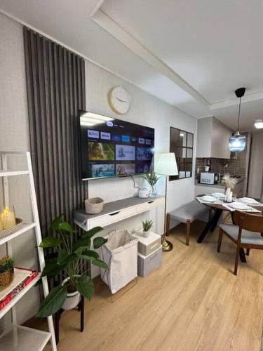 a living room with a desk and a dining room at Cozy Condo in Clark Pampanga with Free Parking & Pool Access in Mabalacat