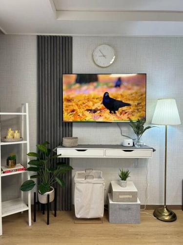 a living room with a flat screen tv on a wall at Cozy Condo in Clark Pampanga with Free Parking & Pool Access in Mabalacat