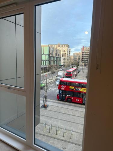 a view from a window of a street with buses at Peaceful shared flat 30mins Central London in Colindale