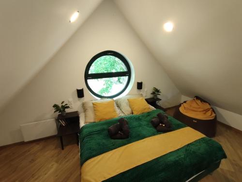 a bedroom with a bed with two brown teddy bears on it at MOHA Weekend in Bánk
