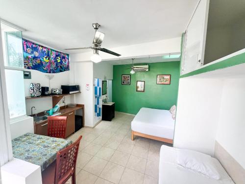 a room with a bedroom with a bed and a table at ITH Sayulita Amazing Surf Hostel in Sayulita