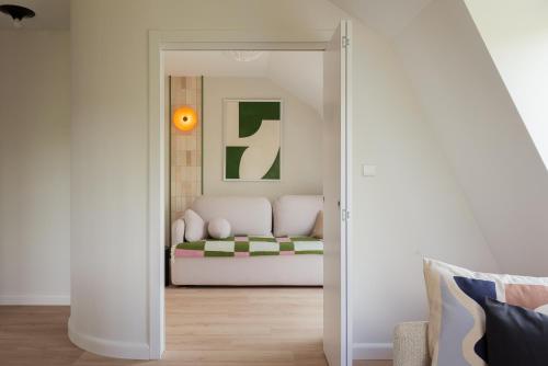 a living room with a couch through a doorway at Sopot M17 - by JWPM in Sopot