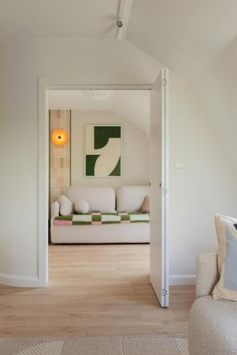 a living room with a couch through a doorway at Sopot M17 - by JWPM in Sopot