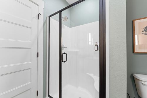 a shower with a glass door in a bathroom at New Ozark Oasis Luxe Cabin Retreat with Hot Tub in Hollister