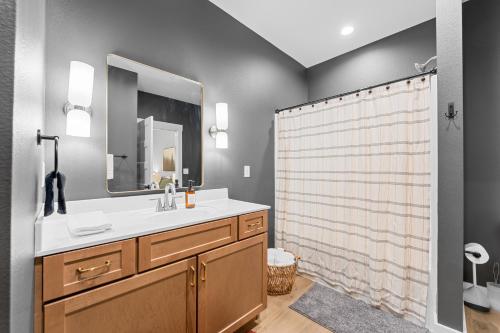 a bathroom with a sink and a shower at New Ozark Oasis Luxe Cabin Retreat with Hot Tub in Hollister