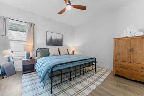a bedroom with a bed and a ceiling fan at New Ozark Oasis Luxe Cabin Retreat with Hot Tub in Hollister