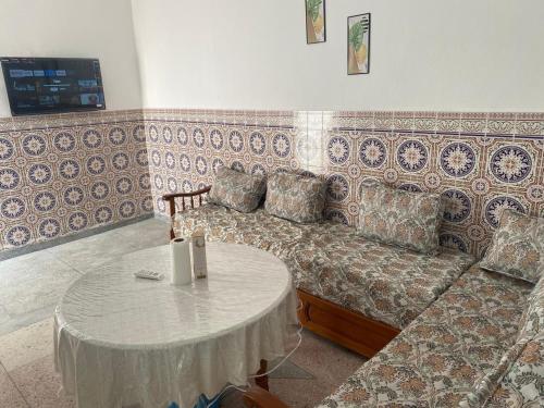 a living room with a couch and a table at Al hoceima Center Apartment in Al Hoceïma