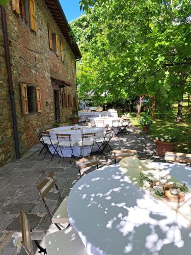 a group of tables sitting outside of a building at Podere Fichereto Tuscany Apartment in Florence countryside in Scandicci