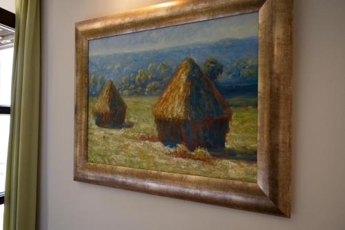 a painting of three tents on a wall at La Boheme Hotel in Gythio