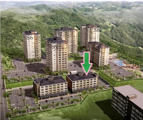 an aerial view of a building with a green arrow on it at Cozy Condo in Clark Pampanga with Free Parking & Pool Access in Mabalacat