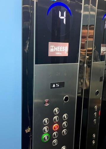a vending machine with a sign on the side of it at Fushe Kosove Cozy Apartment in Kosovo Polje