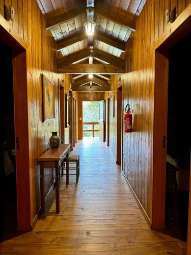 a hallway of a house with wooden walls and wooden floors at Vila Vert - Rancho Queimado - SC in Rancho Queimado