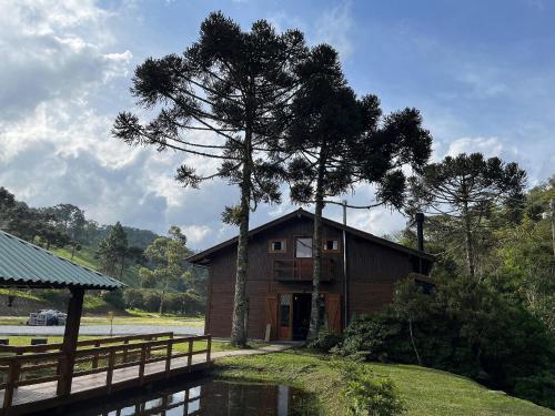 a house with a tree in front of it at Vila Vert - Rancho Queimado - SC in Rancho Queimado