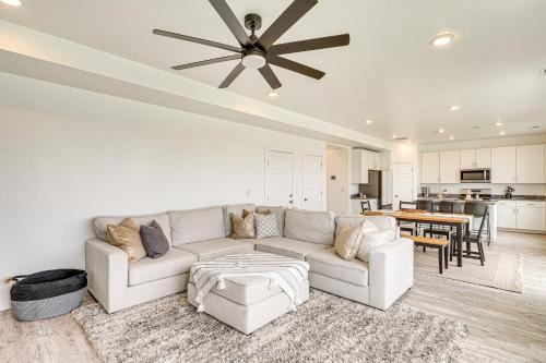 a living room with a couch and a ceiling fan at American Fork Home about 8 Mi to Thanksgiving Point! in American Fork