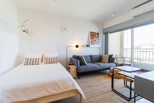 a bedroom with a large bed and a couch at S1405 - practical and modern - AC, balcony and parking in Porto