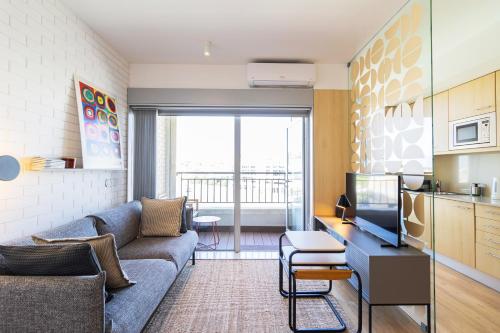 a living room with a couch and a table at S1405 - practical and modern - AC, balcony and parking in Porto