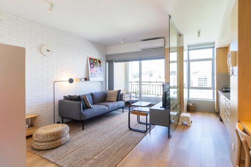 a living room with a couch and a table at S1405 - practical and modern - AC, balcony and parking in Porto