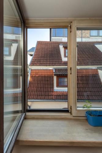 a window with a view of a roof at Amber Private Rooms in Rīga