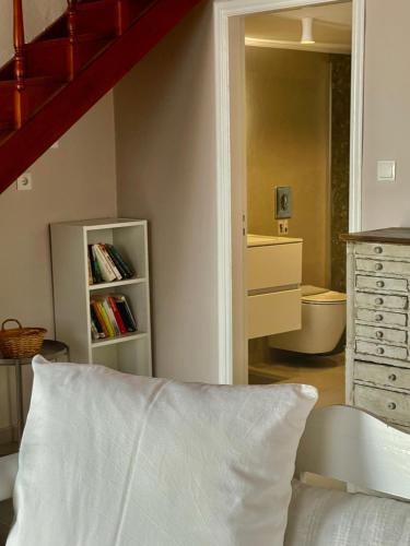 a bedroom with a staircase and a bed and a dresser at Villa Hiona-Seafront Villa in Halki